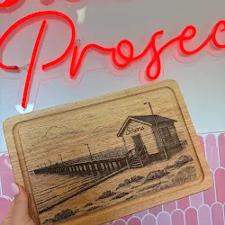 Personalised chopping board with an engraved building design